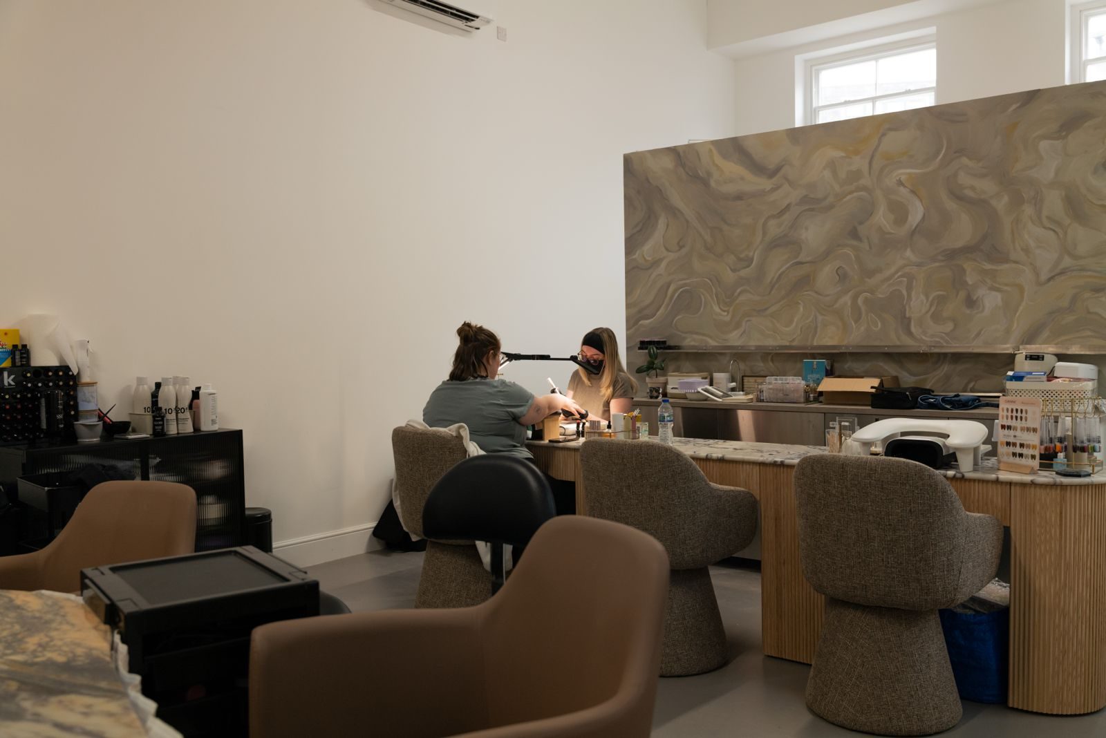 First White Cloth Hall — nail studio with marbled feature wall