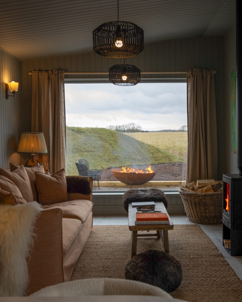 Kip & Nook — living room with fire pit and field view