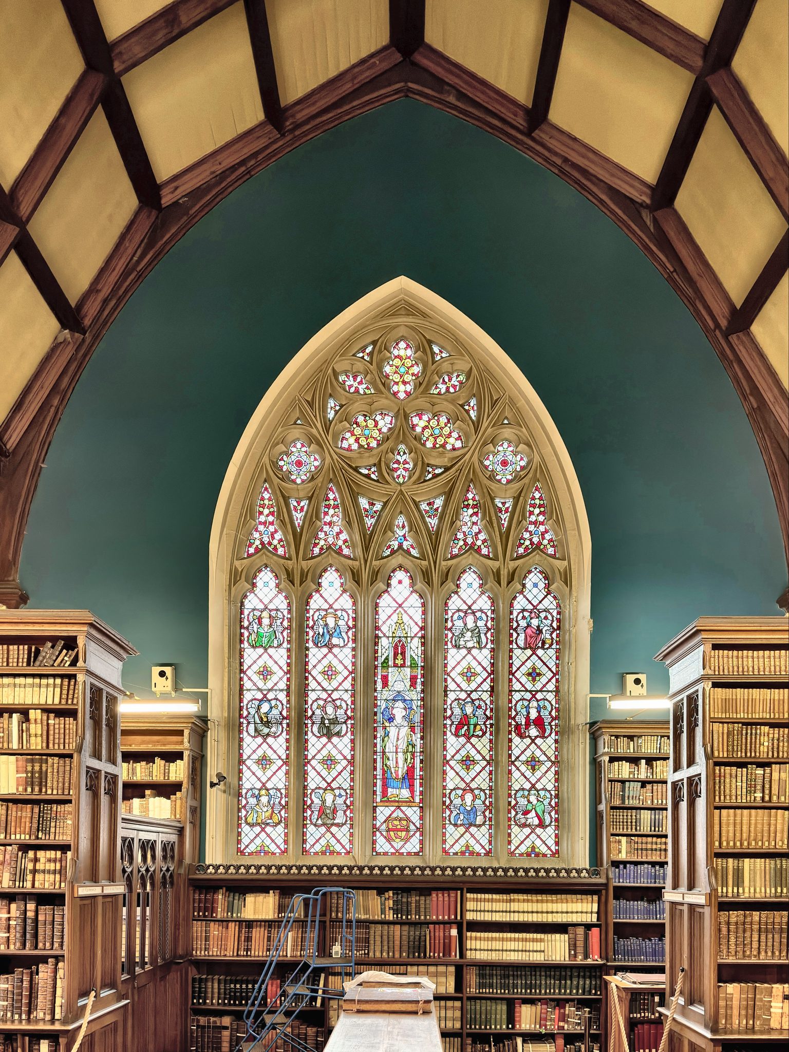 The library interior beneath its great traceried window